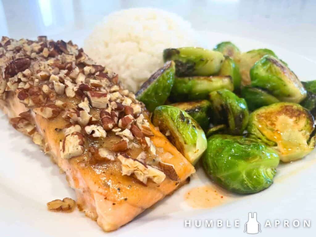 honey pecan salmon on a plate with Brussel sprouts