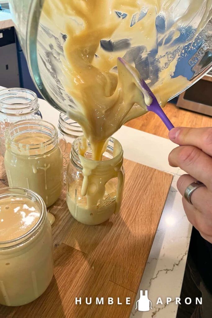 Creamed Honey poured into mason jars