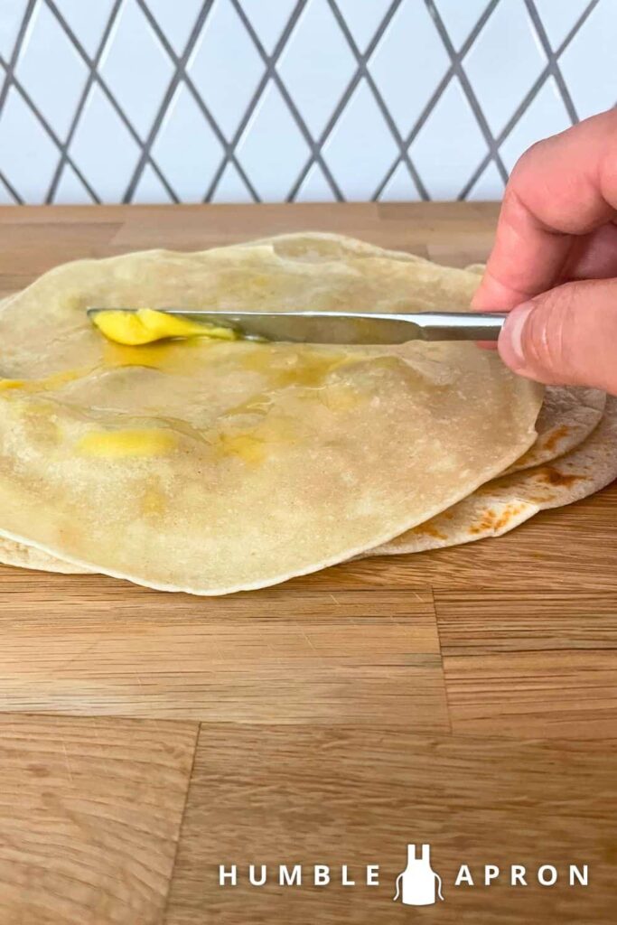 buttering a tortilla