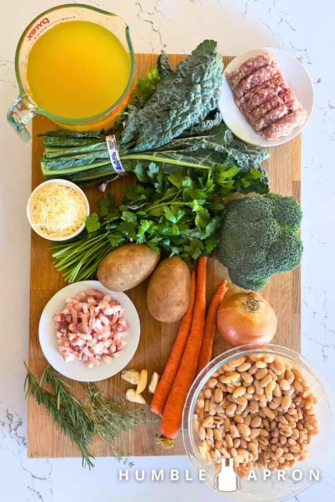 tuscan kale soup with white beans and sausage ingredients on a cutting board